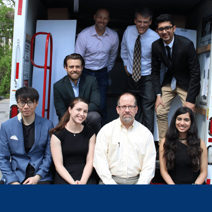 The Trucklite Capstone team, composed of 5 students, pose in the back of the track with the project sponsor and two faculty members.e in the back of a truck with their capstone sponsor - Trucklite - and two faculty members.